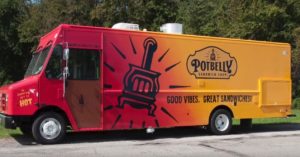 red and orange food truck with graphic of a potbelly stove