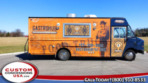 side view of orange food truck with graphic of a man dressed in vintage suit and hat