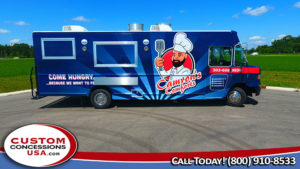 blue food truck with a graphic of a cartoon chef on the side