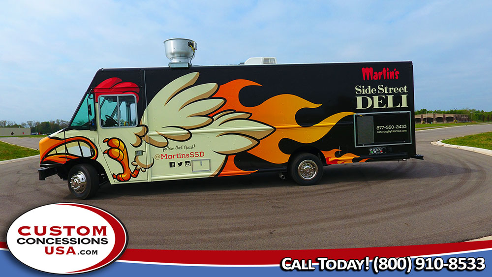 side view of a black food truck with a flaming chicken