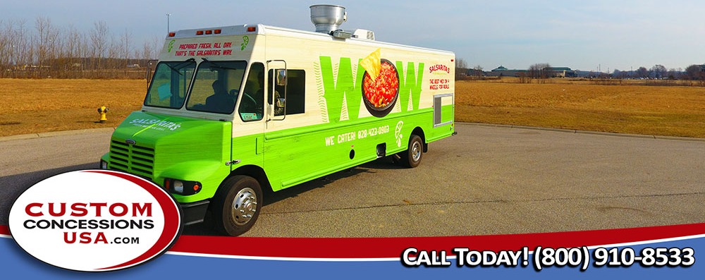 front & side 3/4 view of a green food truck that says WOW on the side