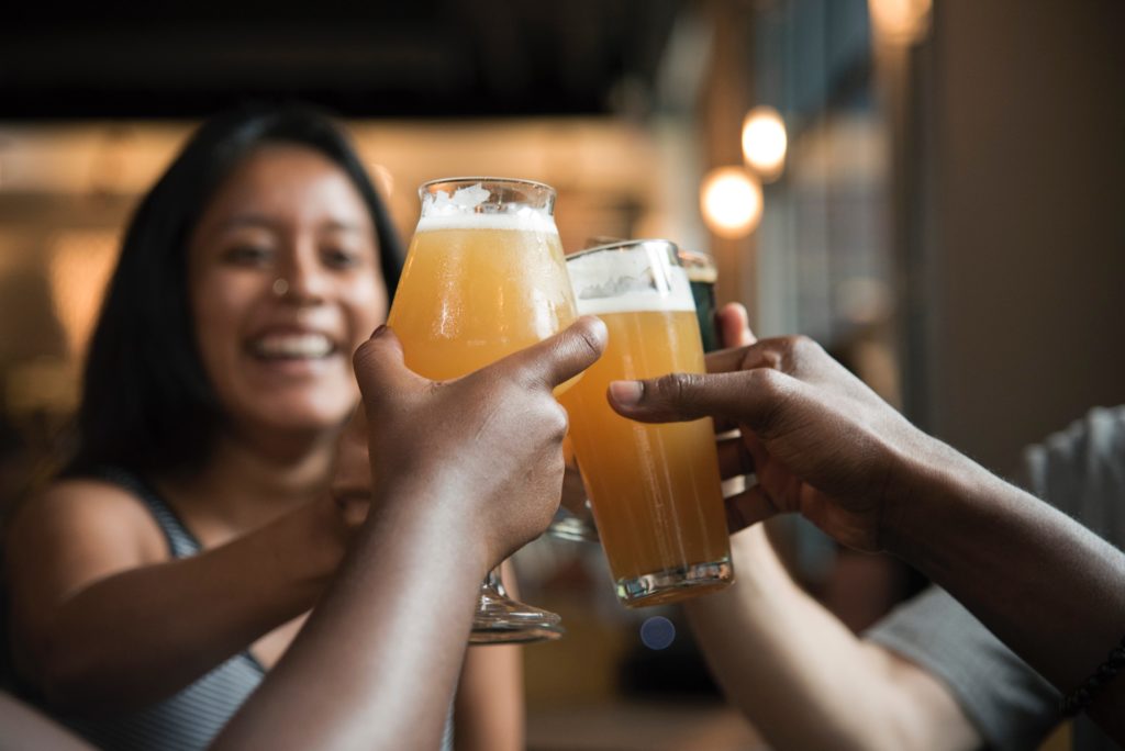 group of friends toasting with glasses of beer