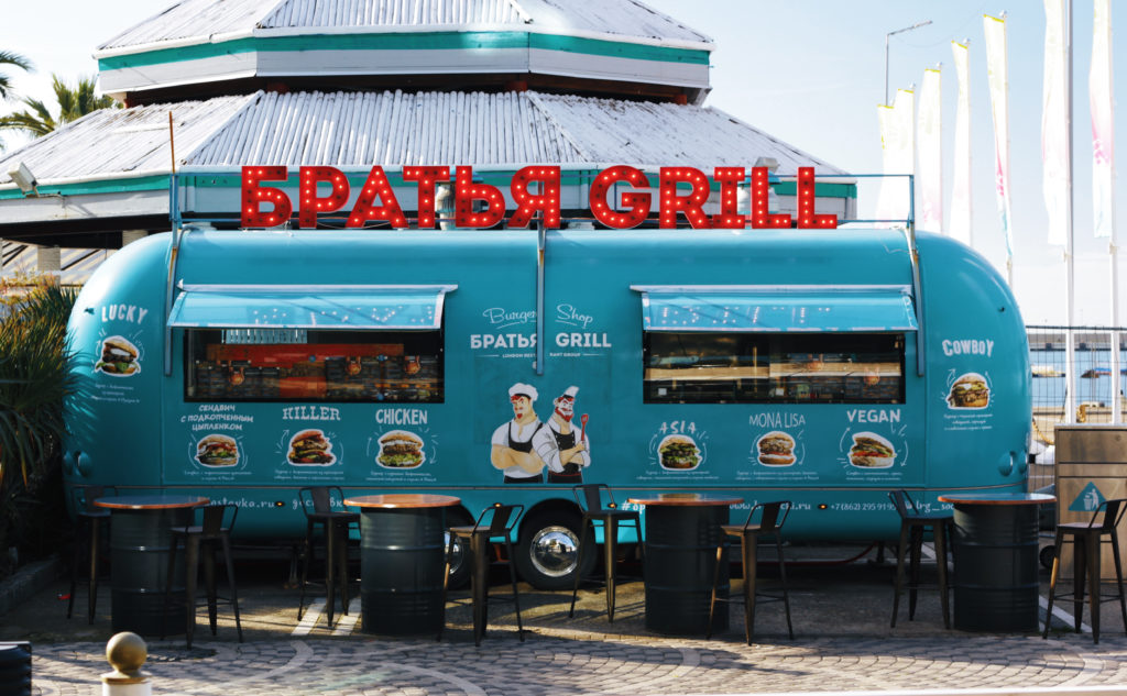 blue vintage food truck parked in urban setting