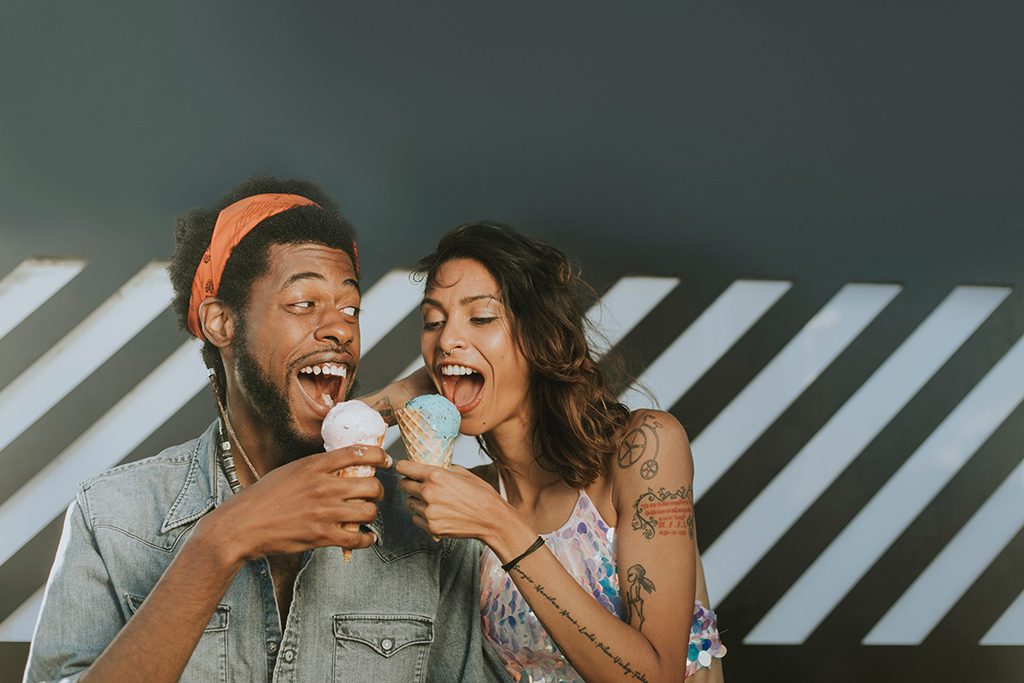 two people of color eating ice cream cones