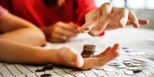 close up photo of adult and child's hands counting coins