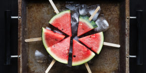 summer watermelon popsicle sticks on a tray with ice cubes