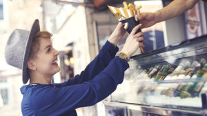 female customer getting fries from a food truck vendor