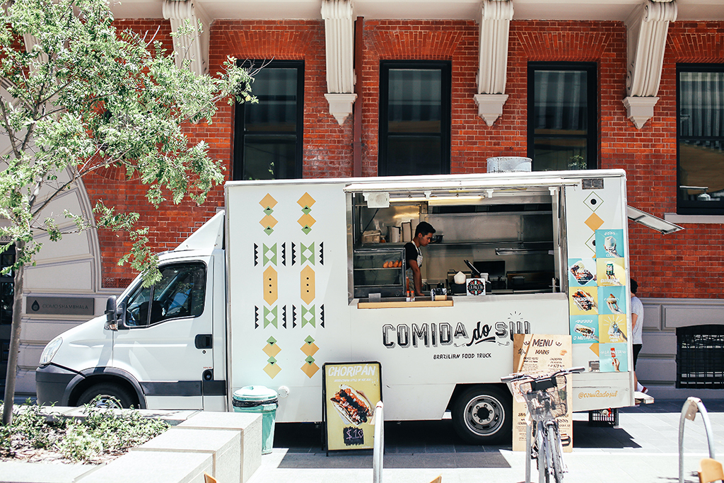 white food truck parked on city street