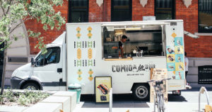 white food truck parked on city street