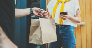 woman receiving food in delivery bag