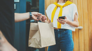 woman receiving food in delivery bag